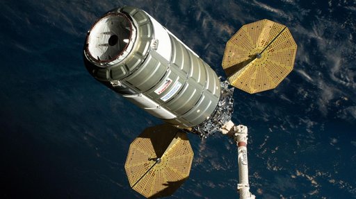 The Cygnus XL cargo spacecraft is held in the grips of the Canadarm2 robotic arm