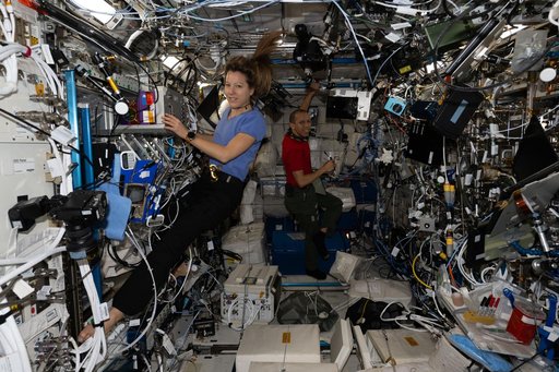 Astronauts Sophie Adenot and Chris Williams work together inside the Columbus laboratory module