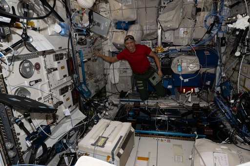 NASA astronaut Chris Williams unpacks computer hardware that supports new exercise gear