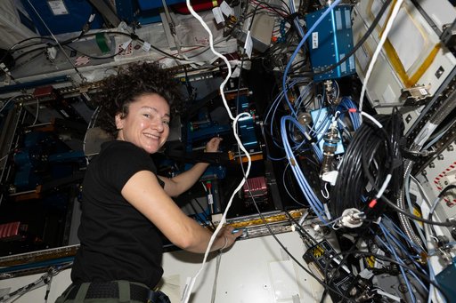 NASA astronaut Jessica Meir replaces components on a new exercise device
