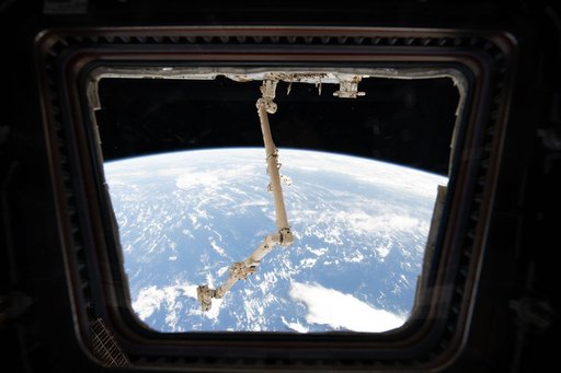 The Canadarm2 robotic arm extends from the Harmony module