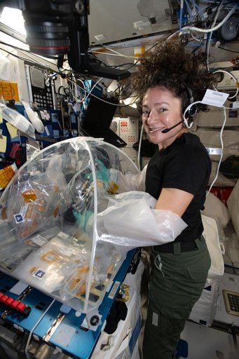 Astronaut Jessica Meir processes samples of heart stem cells and bacteria that cause pneumonia