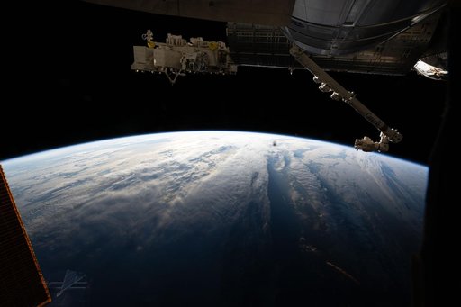 The International Space Station orbits above a cloudy Atlantic Ocean