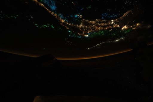 The blue and green lights of fishing boats dot the Gulf of Thailand and the Andaman Sea