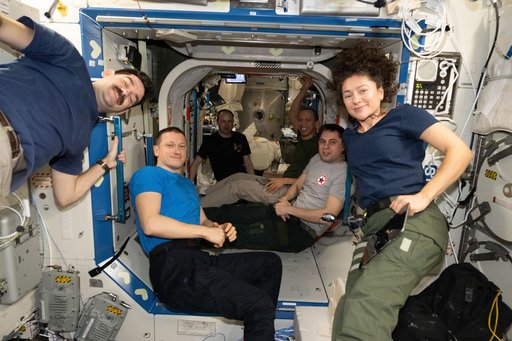Six of seven Expedition 74 crew members pose for a portrait aboard the International Space Station