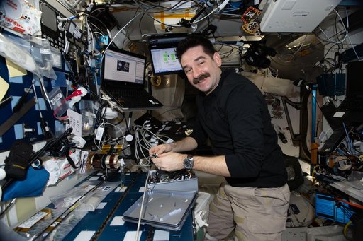 NASA astronaut Jack Hathaway swaps hardware to support a biotechnology study