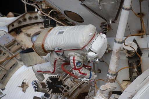 Cosmonaut Sergey Kud-Sverchkov works outside the International Space Station in his Orlan spacesuit with red stripes