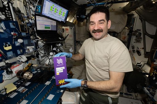 NASA astronaut Jack Hathaway shows off NanoRacks research hardware