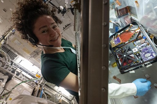 NASA astronaut Jessica Meir sets up research hardware for a blood stem cell investigation