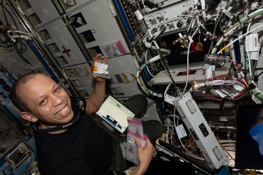 NASA astronaut Chris Williams swaps hard drives inside the Advanced Space Experiment Processor-4