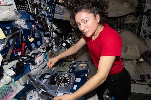 NASA astronaut Jessica Meir removes components from inside the Advanced Space Experiment Processor‑4