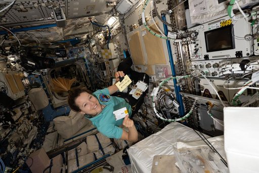 ESA astronaut Sophie Adenot swaps hard drives inside the Advanced Space Experiment Processor-4