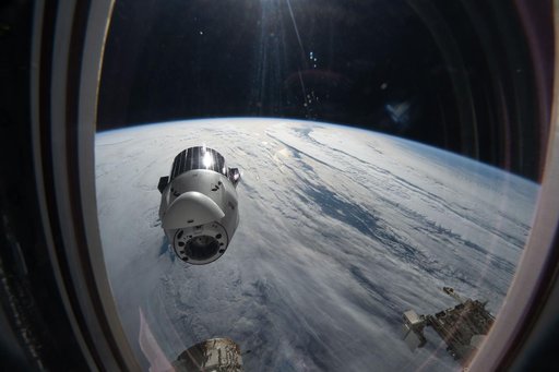 A SpaceX Dragon cargo spacecraft backs away from the International Space Station
