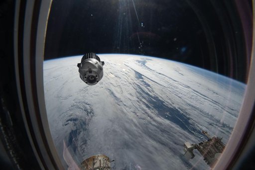 A SpaceX Dragon cargo spacecraft backs away from the International Space Station