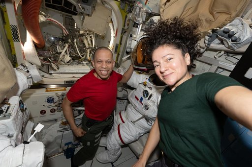 NASA astronauts Jessica Meir and Chris Williams pose for a portrait inside the Quest airlock