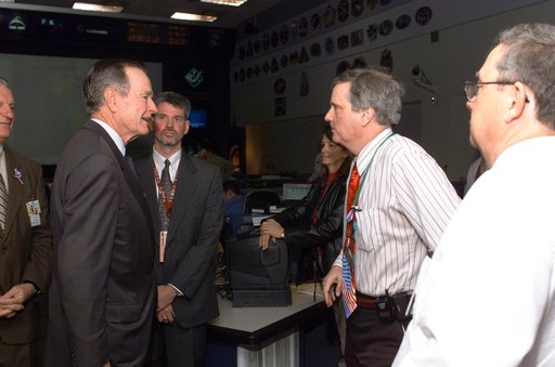 Former President George H. W. Bush and Mrs. Bush visit with Mission Control Center personnel.