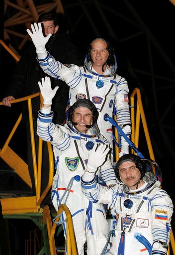 Expedition 13 Crew Members wave goodbye at launch pad