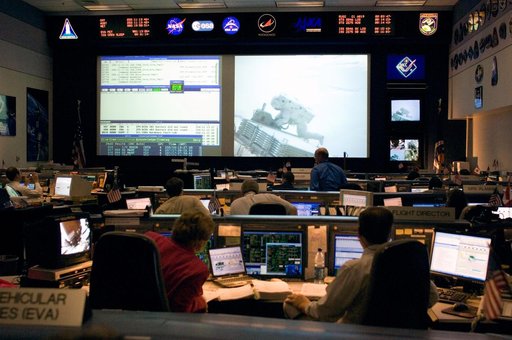 Expedition 13 Flight Controllers on console during mission - Orbit 2 - BFCR during EVA