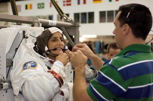 STS-116 crew members during EVA training at the NBL.