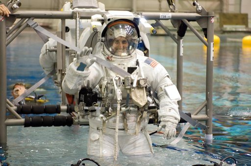 STS-116 crew members during EVA training at the NBL.
