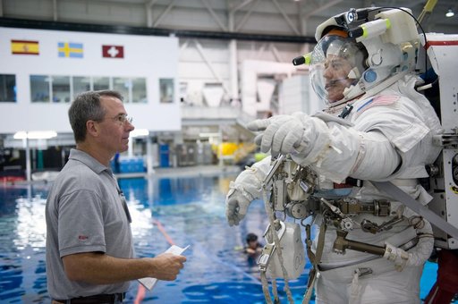 STS-130 crew members George Zamka, Steve Robinson helping Robert Behnken and Nick Patrick