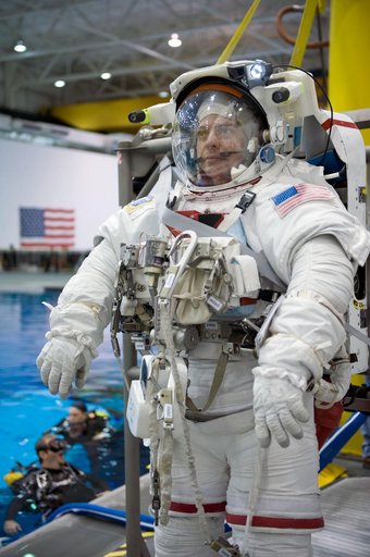 STS-130 crew members George Zamka, Steve Robinson helping Robert Behnken and Nick Patrick