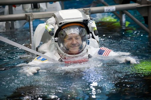 STS-130 crew members George Zamka, Steve Robinson helping Robert Behnken and Nick Patrick