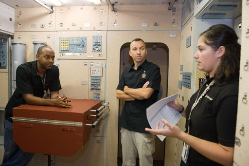 STS-129 crew during trans hands-on review in the space station mockups.