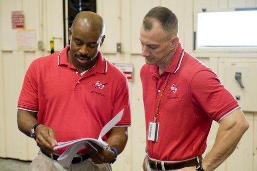 STS-129 crew during trans hands-on review in the space station mockups.
