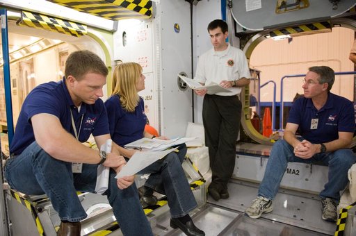 STS-130 crew and Expedition 22 crew member T.J. Creamer during module outfitting training.