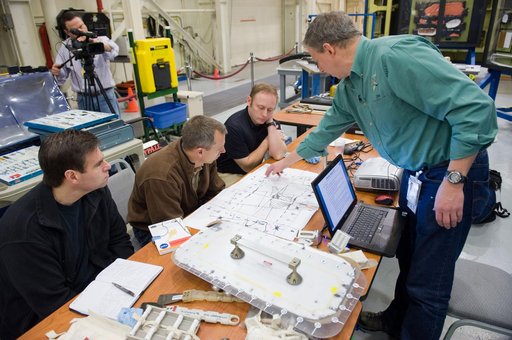 STS-134 crew members Mike Fincke, Drew Feustel and Greg Chamitoff performing EVA Tile Repair Training.