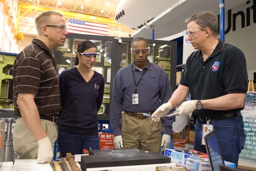 STS-133 crew members  Drew, Kopra and Stott during EVA Tile Repair.