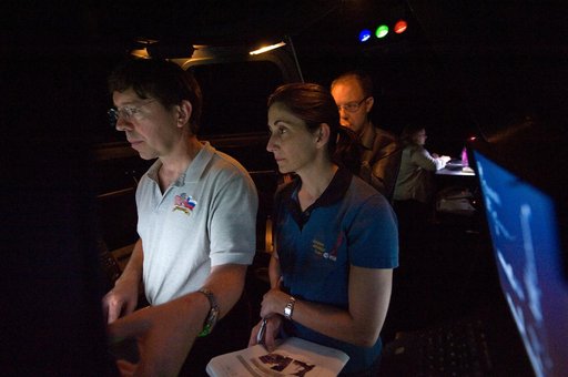 STS-133 crew members Mike Barratt and Nicole Stott in cupola
