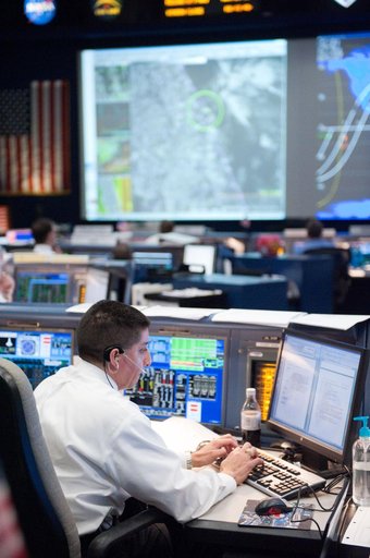 STS-133 flight controllers on console during the launch of Discovery