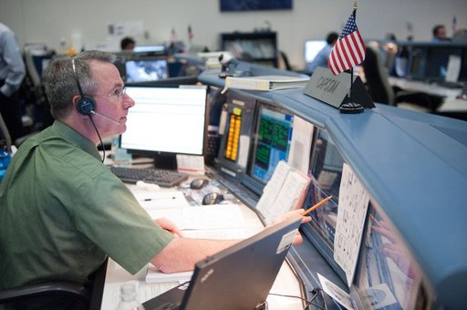 STS-133/ULF5 Orbit 1 flight controllers on console during unberth of Permanent Multipurpose Module (PMM) from shuttle.
