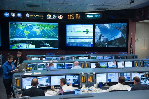 STS-133/ULF5 Orbit 1 flight controllers on console during unberth of Permanent Multipurpose Module (PMM) from shuttle.