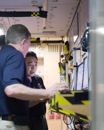 Expedition 28/29 crew members during Docking Timeline Training.