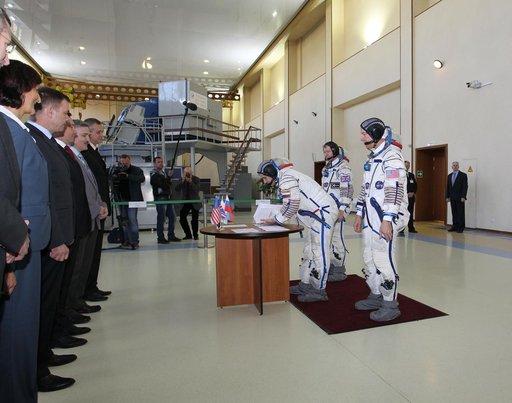 CG4G8740_1 --- (6 May 2015) --- At the Gagarin Cosmonaut Training Center in Star City, Russia, Expedition 44/45 backup Soyuz Commander Yuri Malenchenko of the Russian Federal Space Agency (Roscosmos) signs in for the first of two days of qualification exams May 6 as his crewmates, Timothy Peake of t
