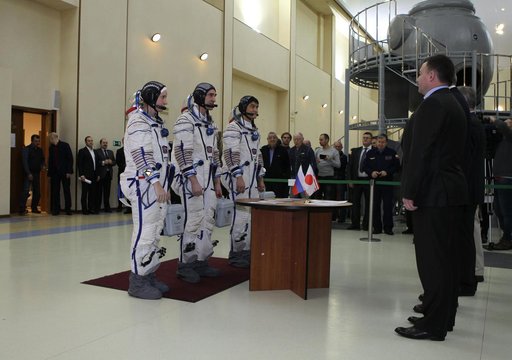 At the Gagarin Cosmonaut Training Center in Star City, Russia, Expedition 46-47 backup crewmembers Kate Rubins of NASA (left), Anatoly Ivanishin of the Russian Federal Space Agency (Roscosmos, center) and Takuya Onishi of the Japan Aerospace Exploration Agency (right) check in with Russian space off