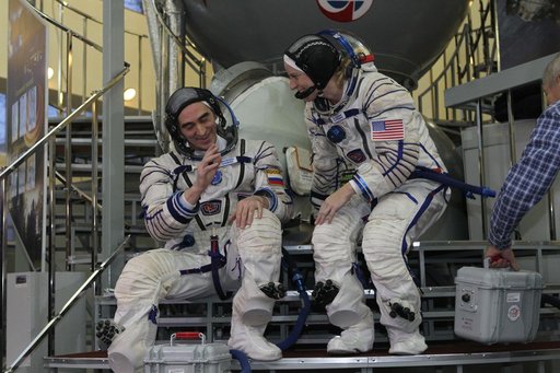 At the Gagarin Cosmonaut Training Center in Star City, Russia, Expedition 46-47 backup crewmembers Anatoly Ivanishin of the Russian Federal Space Agency (Roscosmos, left) and Kate Rubins of NASA prepare to enter a Soyuz simulator Nov. 19 at the start of qualification exams. Along with Takuya Onishi 