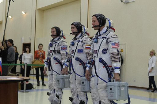 At the Gagarin Cosmonaut Training Center in Star City, Russia, Expedition 46-47 crewmembers Tim Peake of the European Space Agency (left), Yuri Malenchenko of the Russian Federal Space Agency (Roscosmos, center) and Tim Kopra of NASA (right) report for their qualification exams Nov. 20. The trio wil