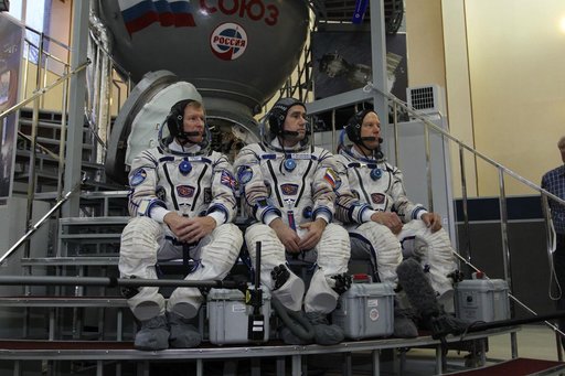 At the Gagarin Cosmonaut Training Center in Star City, Russia, Expedition 46-47 crewmembers Tim Peake of the European Space Agency (left), Yuri Malenchenko of the Russian Federal Space Agency (Roscosmos, center) and Tim Kopra of NASA (right) listen to reporters��� questions at the start of their fin