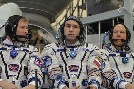 At the Gagarin Cosmonaut Training Center in Star City, Russia, Expedition 46-47 crewmember Yuri Malenchenko of the Russian Federal Space Agency (Roscosmos) responds to a reporter���s question Nov. 20 during final qualification exams. Looking on are crewmates Tim Peake of the European Space Agency (l