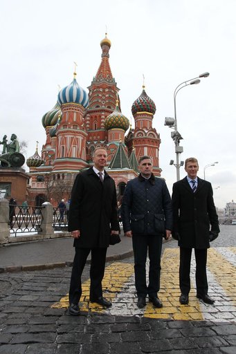 With St. Basil���s Cathedral in Red Square in Moscow serving as a backdrop, Expedition 46-47 crewmembers Tim Kopra of NASA (left), Yuri Malenchenko of the Russian Federal Space Agency (Roscosmos, center) and Tim Peake of the European Space Agency (right) pose for pictures Nov. 23 after laying flower