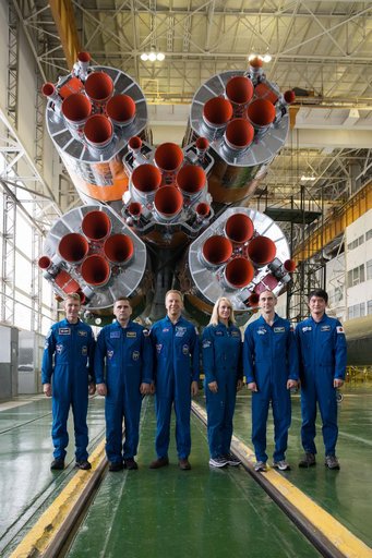 In the Integration Facility at the Baikonur Cosmodrome in Kazakhstan, the prime and backup Expedition 46-47 crewmembers posed for pictures Dec. 10 in front of the first stage of the Soyuz booster rocket during final pre-launch training. From left to right are prime crewmembers Tim Peake of the Europ