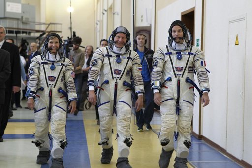 At the Gagarin Cosmonaut Training Center in Star City, Russia, Expedition 48-49 backup crewmembers Peggy Whitson of NASA (left), Oleg Novitskiy of Roscosmos (center) and Thomas Pesquet of the European Space Agency (right) arrive for Soyuz qualification exams May 26. They are serving as the backups t