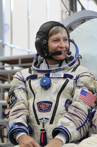 At the Gagarin Cosmonaut Training Center in Star City, Russia, Expedition 48-49 backup crewmember Peggy Whitson of NASA flashes a smile in front of a Soyuz simulator May 26 during final qualification exams. Whitson, Thomas Pesquet of the European Space Agency and Oleg Novitskiy of Roscosmos are serv