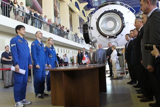 At the Gagarin Cosmonaut Training Center in Star City, Russia, Expedition 48-49 prime crewmembers Takuya Onishi of the Japan Aerospace Exploration Agency (left), Anatoly Ivanishin of Roscosmos (center) and Kate Rubins of NASA (right) report to officials May 26 at the start of final qualification exa