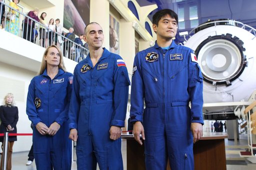 At the Gagarin Cosmonaut Training Center in Star City, Russia, Expedition 48-49 prime crewmembers Kate Rubins of NASA (left), Anatoly Ivanishin of Roscosmos (center) and Takuya Onishi of the Japan Aerospace Exploration Agency (right) pose for pictures May 26 during a final qualification exam session