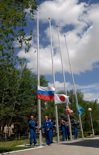 Outside their Cosmonaut Hotel crew quarters in Baikonur, Kazakhstan, the Expedition 48-49 prime and backup crewmembers conduct the traditional raising of the Russian, Japanese, American and Kazakh flags June 26. Prime crewmembers Kate Rubins of NASA, Anatoly Ivanishin of Roscosmos and Takuya Onishi 